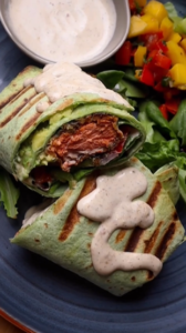 A close up of a burrito on top of a plate